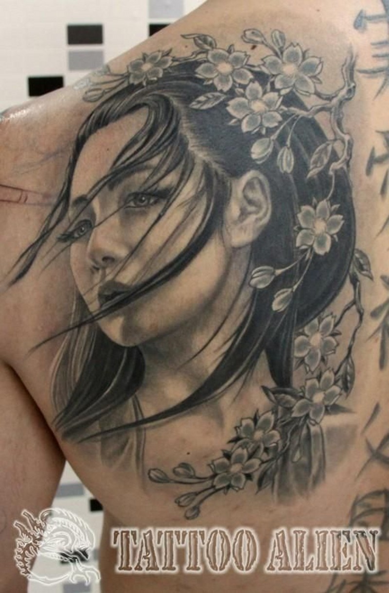 Magical looking colored beautiful Asian woman portrait tattoo on shoulder with blooming flowers