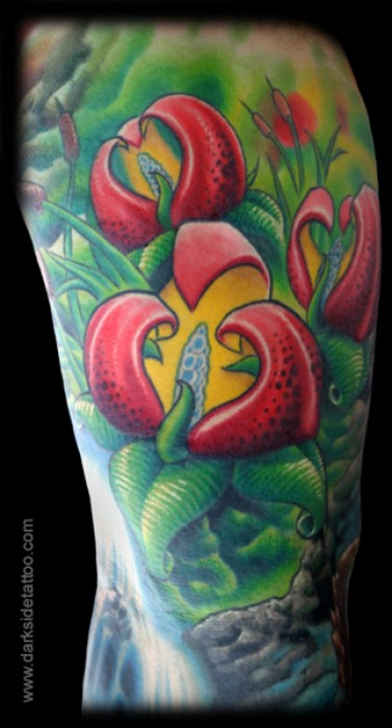 Magical looking colored shoulder tattoo of beautiful flowers with leaves