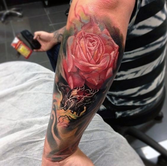 Magnificent 3D style big colored detailed rose tattoo on forearm with skull