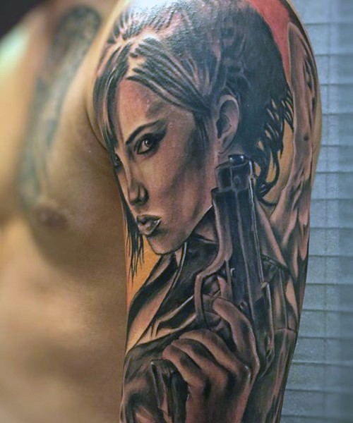 Magnificent angel woman with pistol tattoo on shoulder