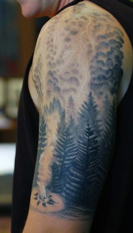 Magnificent black and white lightning shoulder tattoo with forest picture