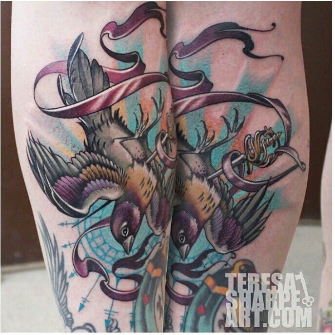 Magnificent cartoon like colored flying bird tattoo on arm with ribbon
