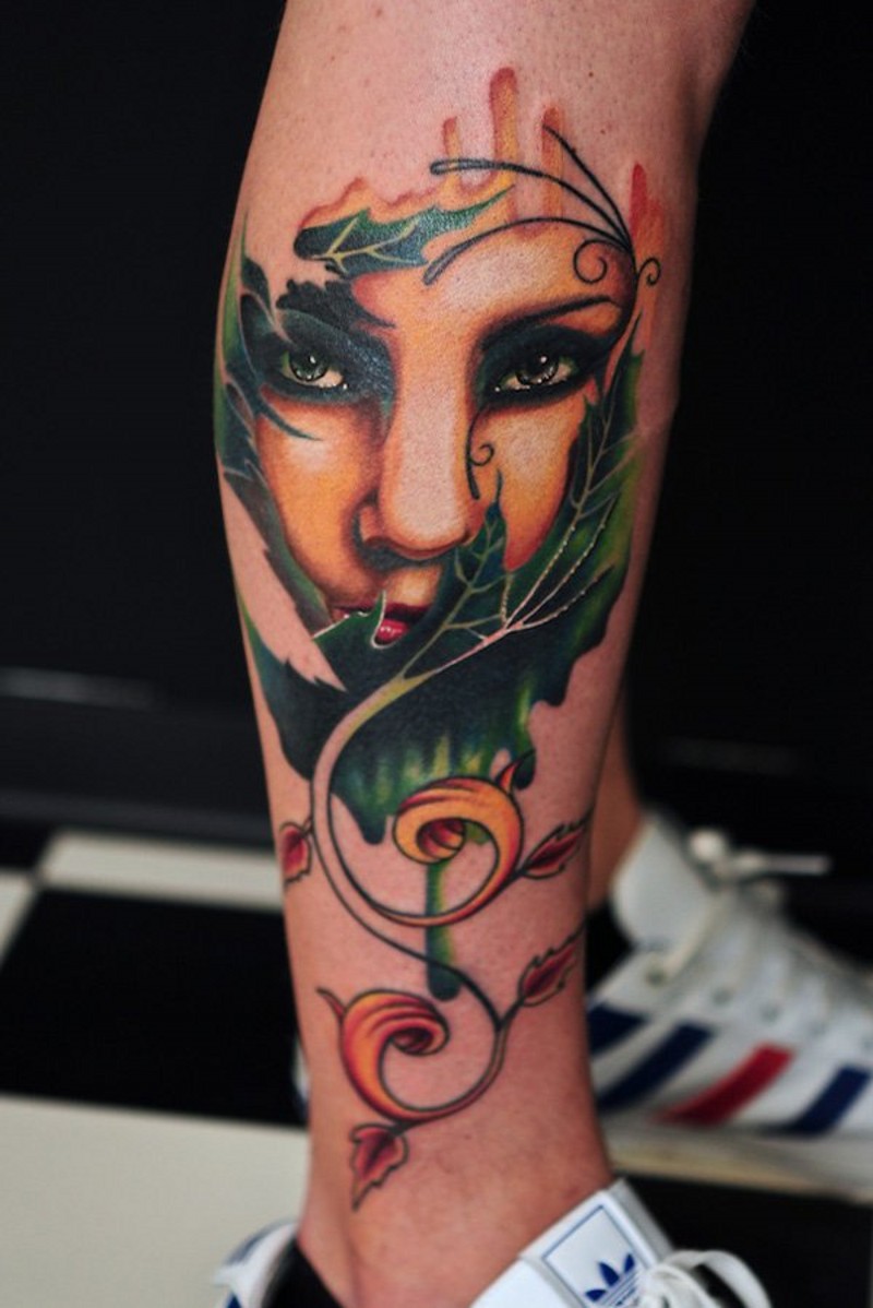 Magnificent colored mystical woman portrait tattoo on leg combined with leaves