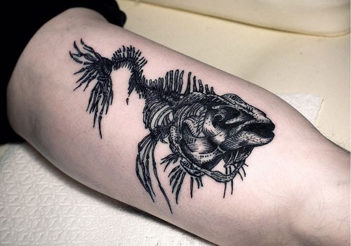 Magnificent dark engraving style biceps tattoo of fish skeleton