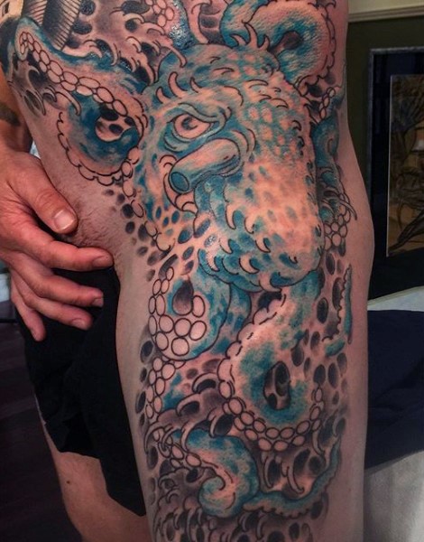Magnificent designed and colored massive octopus tattoo on thigh and waist