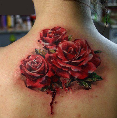 Magnificent designed big red roses growing from back tattoo