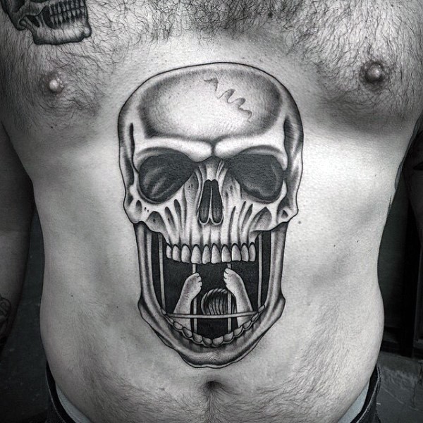 Magnificent looking colored belly tattoo of human skull and grille