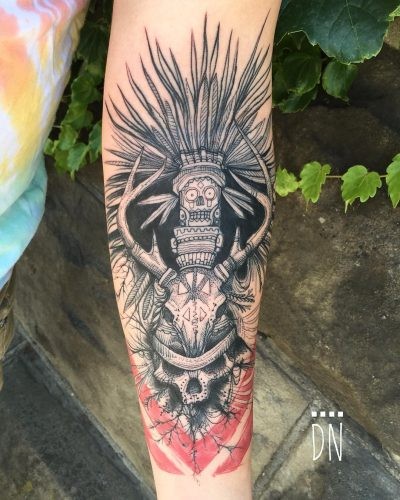 Magnificent looking colored forearm tattoo of cult skull with totem and red lines