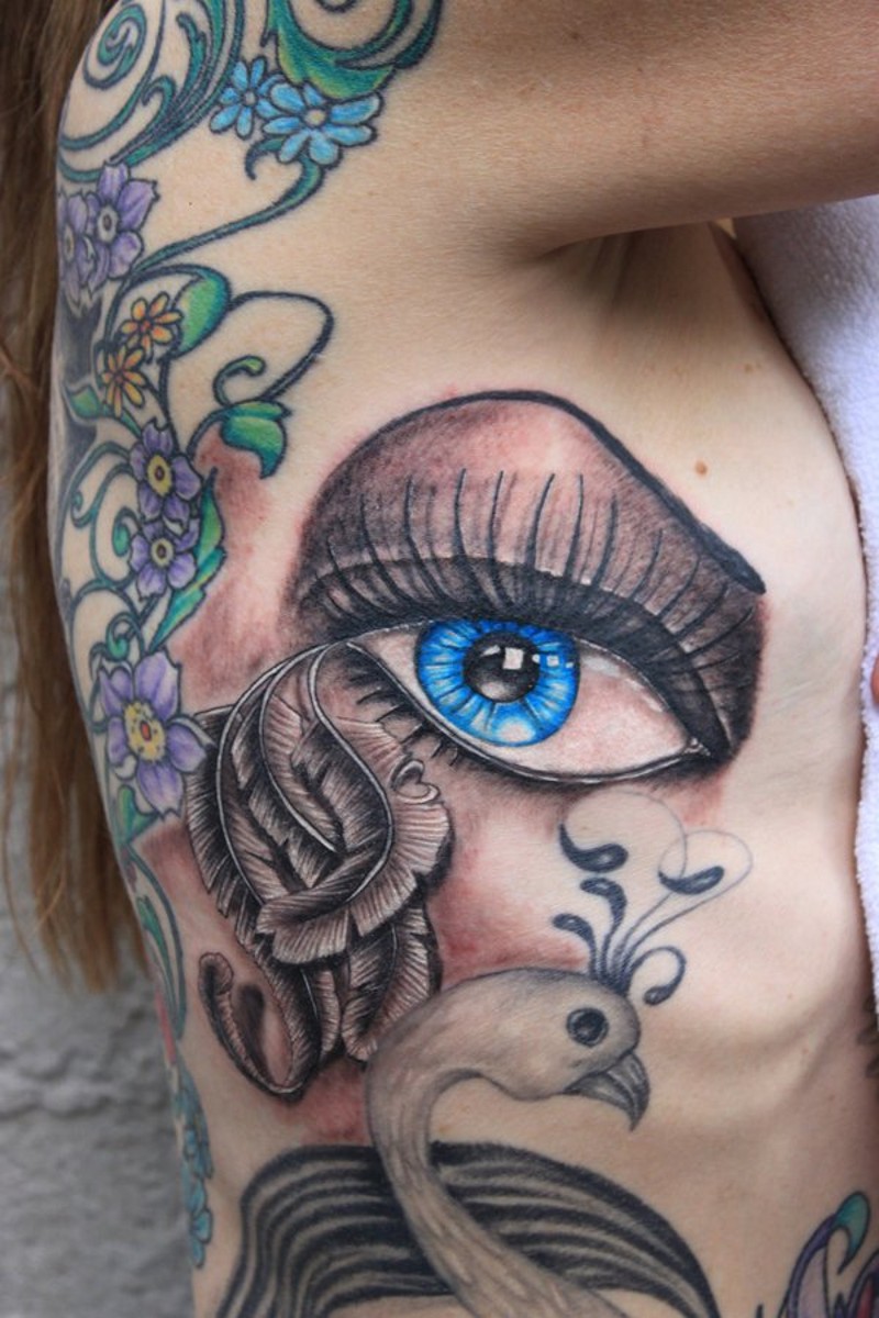 Magnificent painted big blue eye tattoo on side