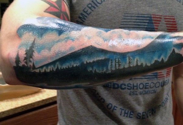 Magnificent real panoramic photo like big mountain forest tattoo on sleeve