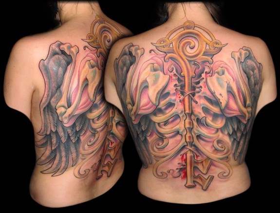 Tatuaje en la espalda,
bastón con alas y huesos