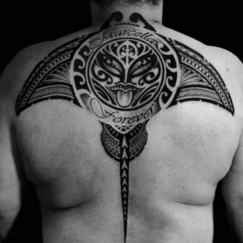 Marvelous big black ink ray tattoo on back stylized with tribal ornaments and lettering