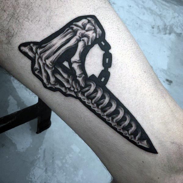Marvelous black and white leg tattoo of bone hand with bone dagger