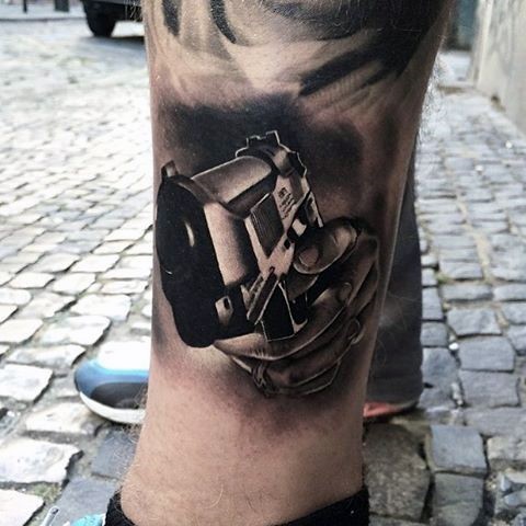 Marvelous black ink 3D style leg tattoo of modern pistol