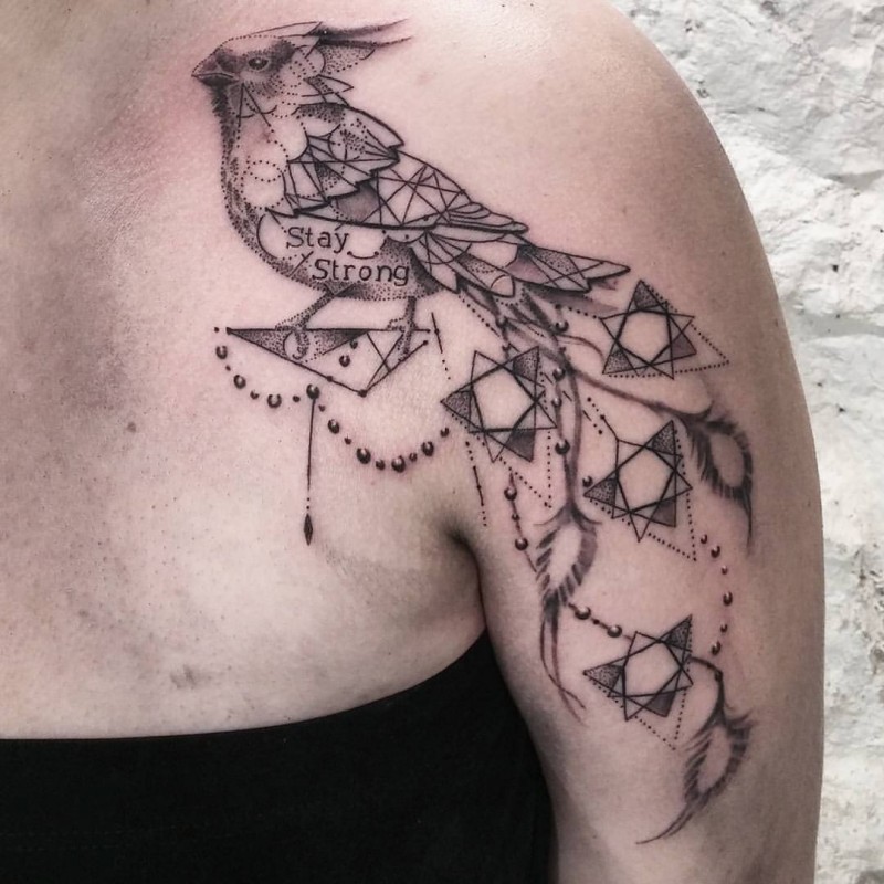 Marvelous black ink shoulder tattoo of big bird with lettering and figures