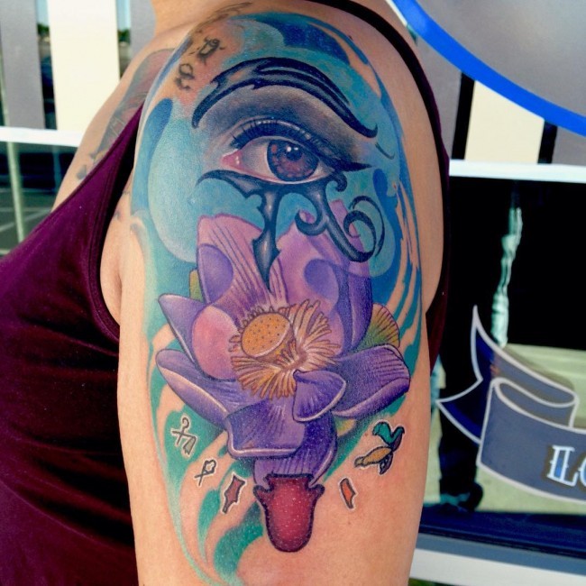 Marvelous multicolored shoulder tattoo of beautiful flower and Eye of Horus symbol