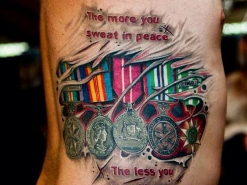 Marvelous multicolored tattoo of various medals and lettering