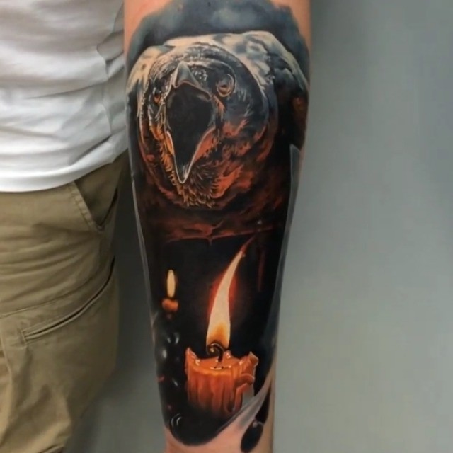 Marvelous natural looking colored crow tattoo on forearm with burning candle