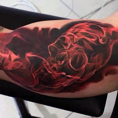 Marvelous red colored biceps tattoo of steamy skull