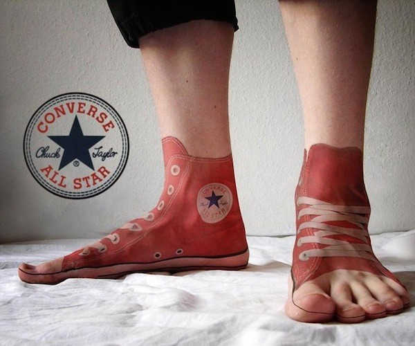 Marvelous very detailed and colored feet tattoo of real shoes