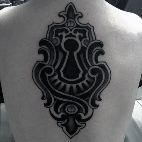 Massive black and white mystical lock tattoo on back