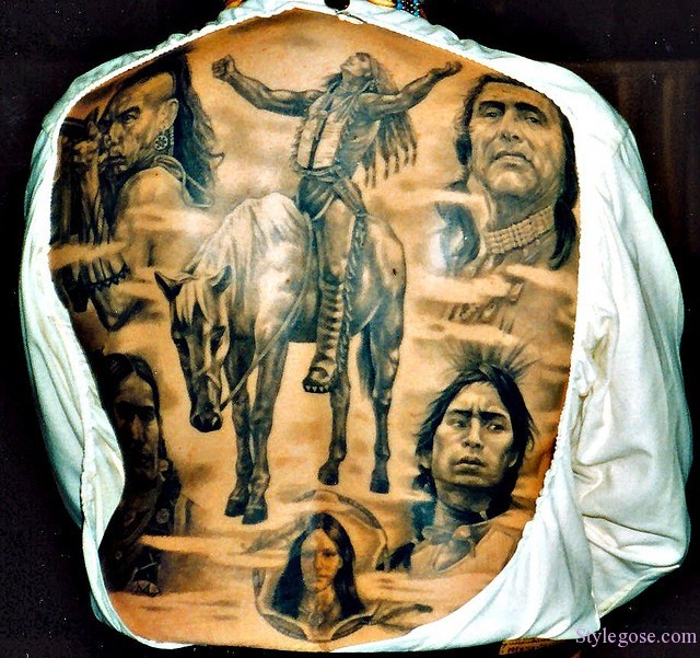 Massive black and white very detailed whole back tattoo of various Indians