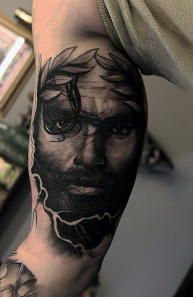 Massive black ink antic detailed portrait tattoo on arm