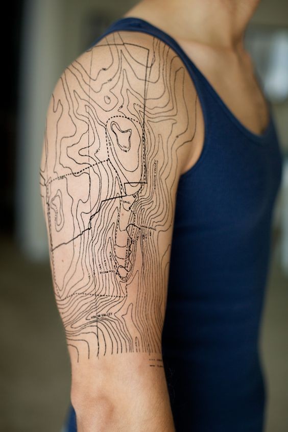 Massive black ink realistic looking shoulder tattoo of map part