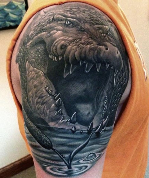 Massive horrifying detailed alligator tattoo on upper arm