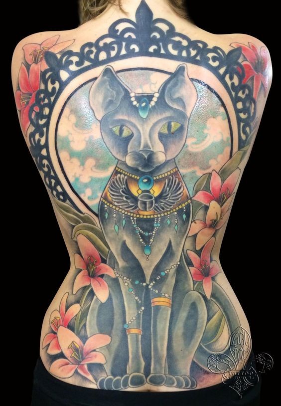 Massive multicolored Egypt cat tattoo on whole back stylized with various flowers