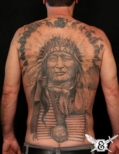 Massive real photo like black and white very detailed on whole back tattoo of old Indian chief with necklace