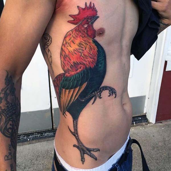 Massive very realistic looking colorful cock tattoo on side