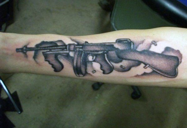 Medium size black and gray style forearm tattoo of Tommy gun