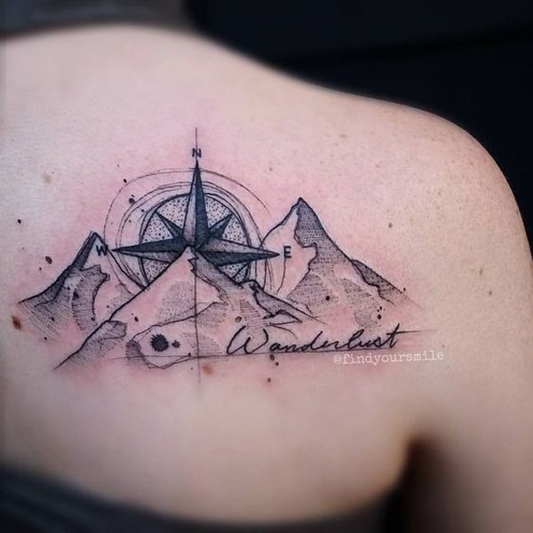 Medium size black and white mountains with compass tattoo on shoulder with lettering