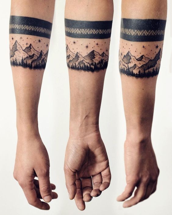 Medium size black ink forearm tattoo of night mountains