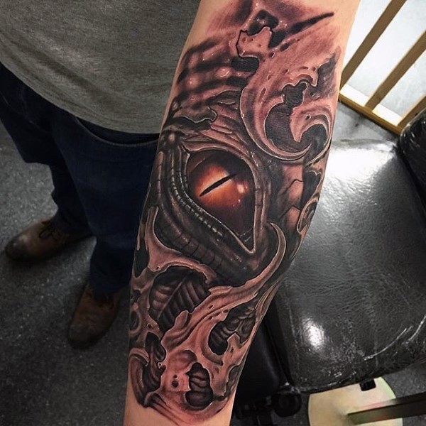 Medium size colored illustrative style dragon eye tattoo on forearm