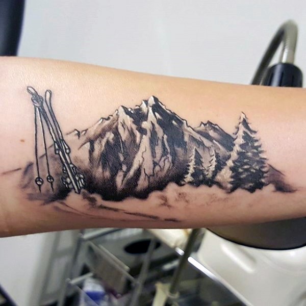 Medium size illustrative style mountains tattoo on arm