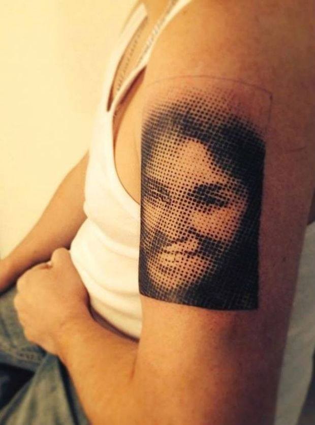 Medium size stippling style black ink shoulder tattoo of woman portrait