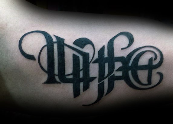 Medium size typical black ink ambigram tattoo on arm
