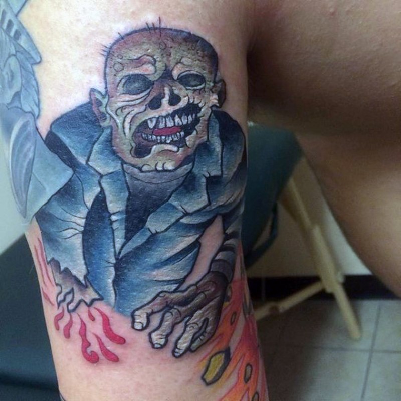 Medium sized colored homemade colored monster zombie tattoo on biceps