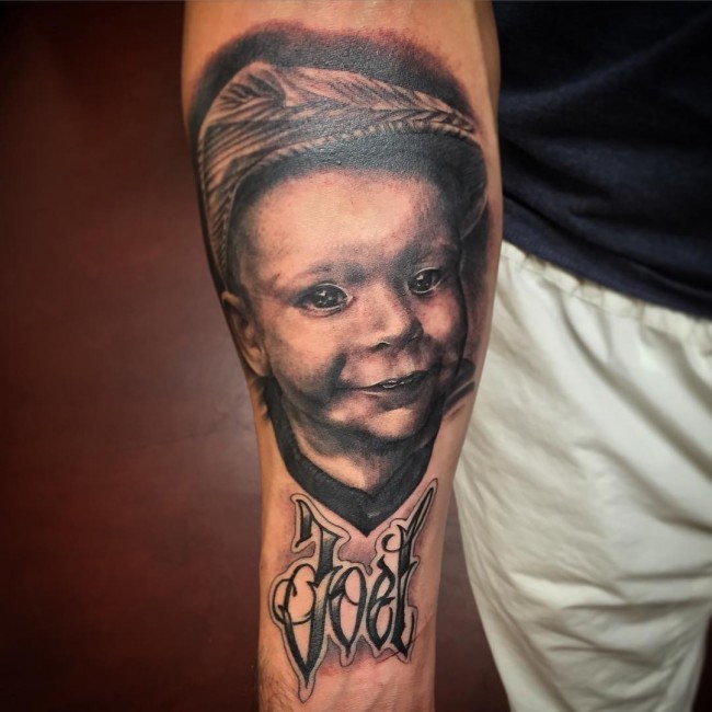 Memorial style black and gray style forearm tattoo of boy portrait and lettering