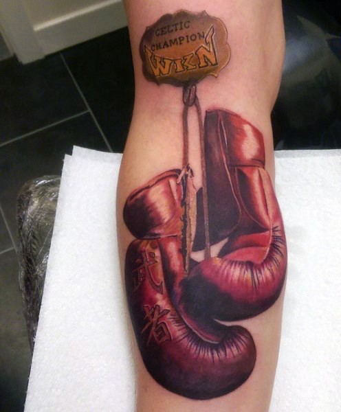 Memorial style colored boxer gloves with lettering tattoo on arm