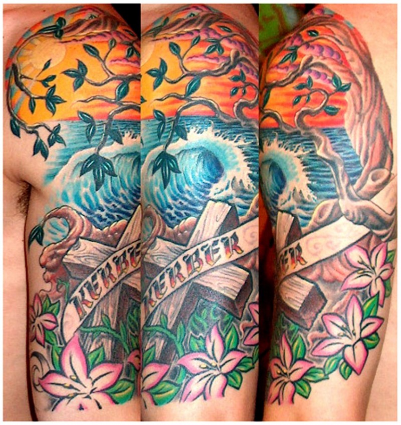 Memorial style multicolored ocean shore half sleeve tattoo with cross and lettering
