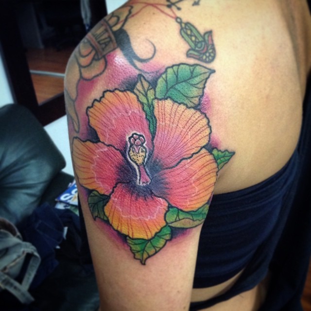 Mesmerizing colored hibiscus flower Hawaiian themed tattoo on shoulder with violet haze