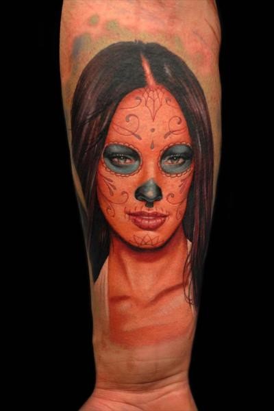 Mexican style colored arm tattoo of woman face with ornaments