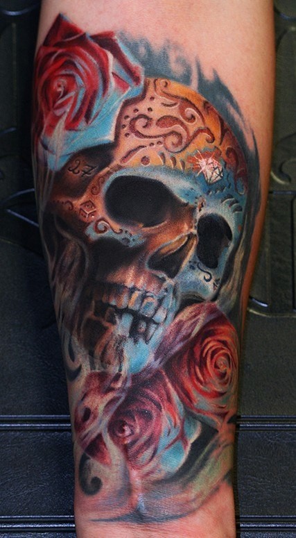Mexican style colored forearm tattoo of human skull with roses