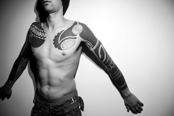 Missive black ink tribal style tattoo on sleeve