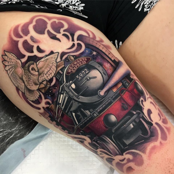Modern looking beautiful painted train tattoo with owl