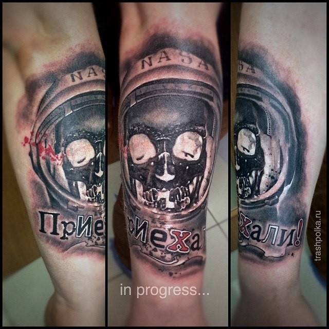 Modern style colored arm tattoo of astronaut with skeleton and lettering