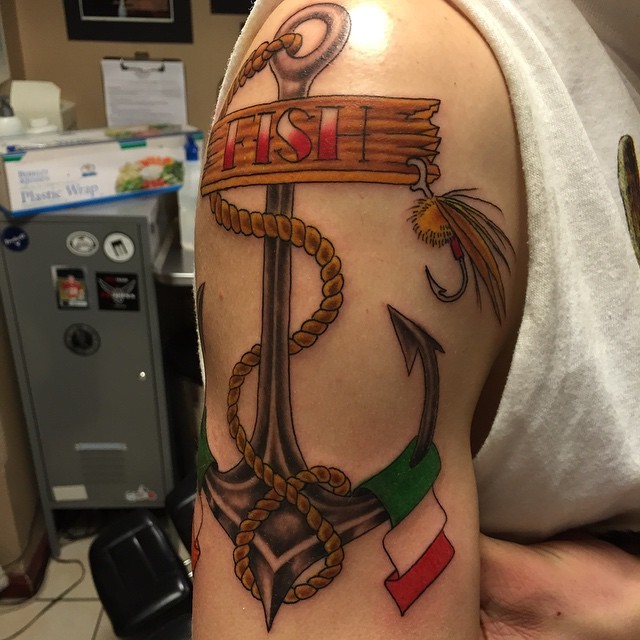 Modern style colored shoulder tattoo of anchor with lettering and rope